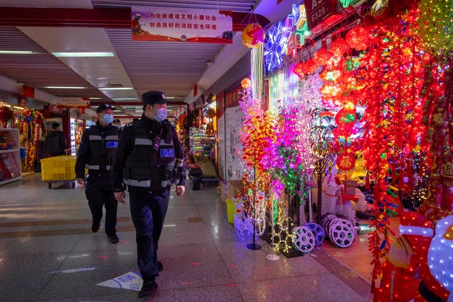 <p>File photo: Police officers patrol inspect Christmas and New Year decorations in Yiwu, China, 11 December 2020</p>