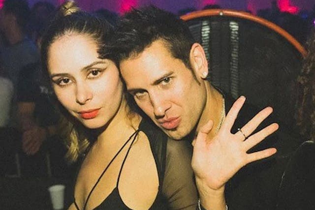 <p>Hilda Marcela Cabrales-Arzola, 26, poses with David Pearce at an after-hours warehouse party in downtown LA on 13 November 2021 </p>