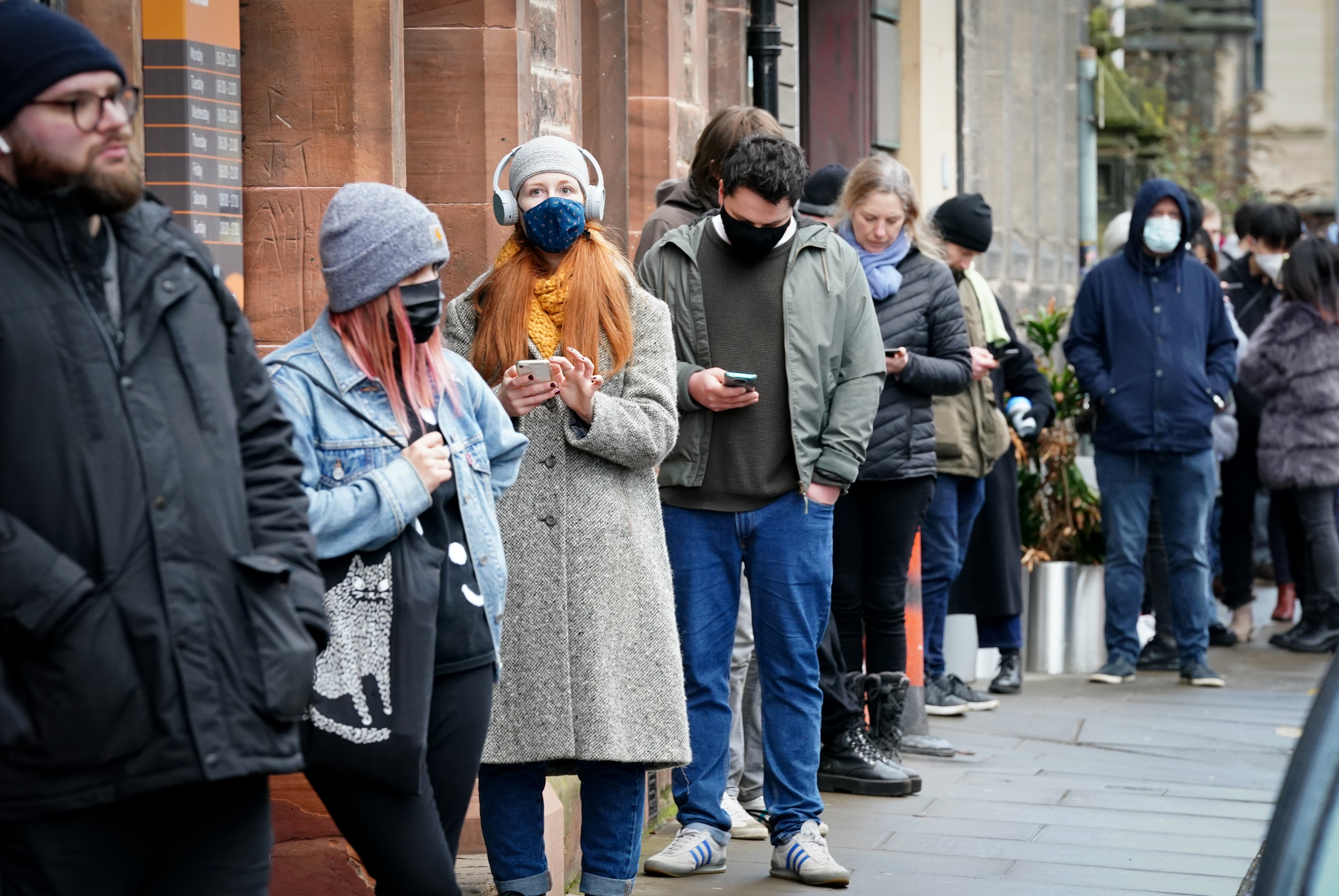 People queue along Junction Place, Edinburgh, for the vaccination centre at the NHS Scotland Leith Community Treatment Centre (Jane Barlow/ PA)