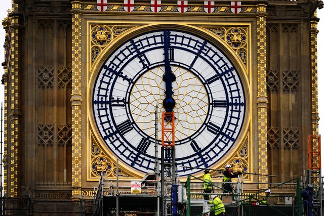 Construction workers remove the scaffolding from the restored west dial of the clock on Elizabeth Tower, known as Big Ben, at the Palace of Westminster (Victoria Jones/PA)