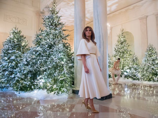 <p>US First Lady Melania Trump stands in the Grand Foyer as she tours Christmas decorations at the White House in Washington, DC, November 27, 2017</p>