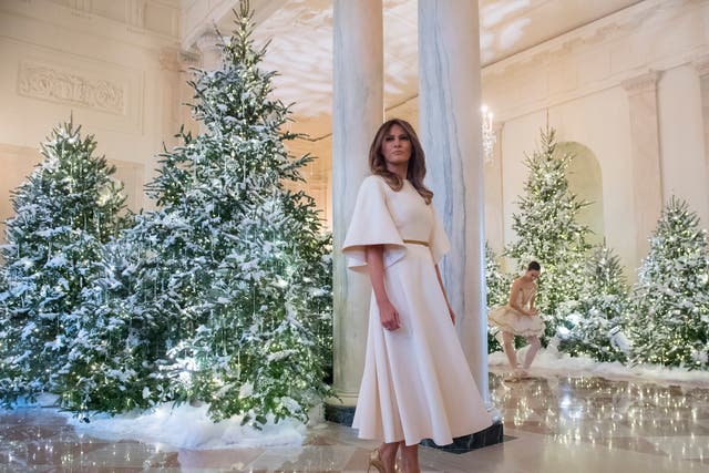 <p>US First Lady Melania Trump stands in the Grand Foyer as she tours Christmas decorations at the White House in Washington, DC, November 27, 2017</p>