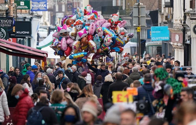 Christmas shoppers make their way along the High Street in Winchester (Andrew Matthews/PA)