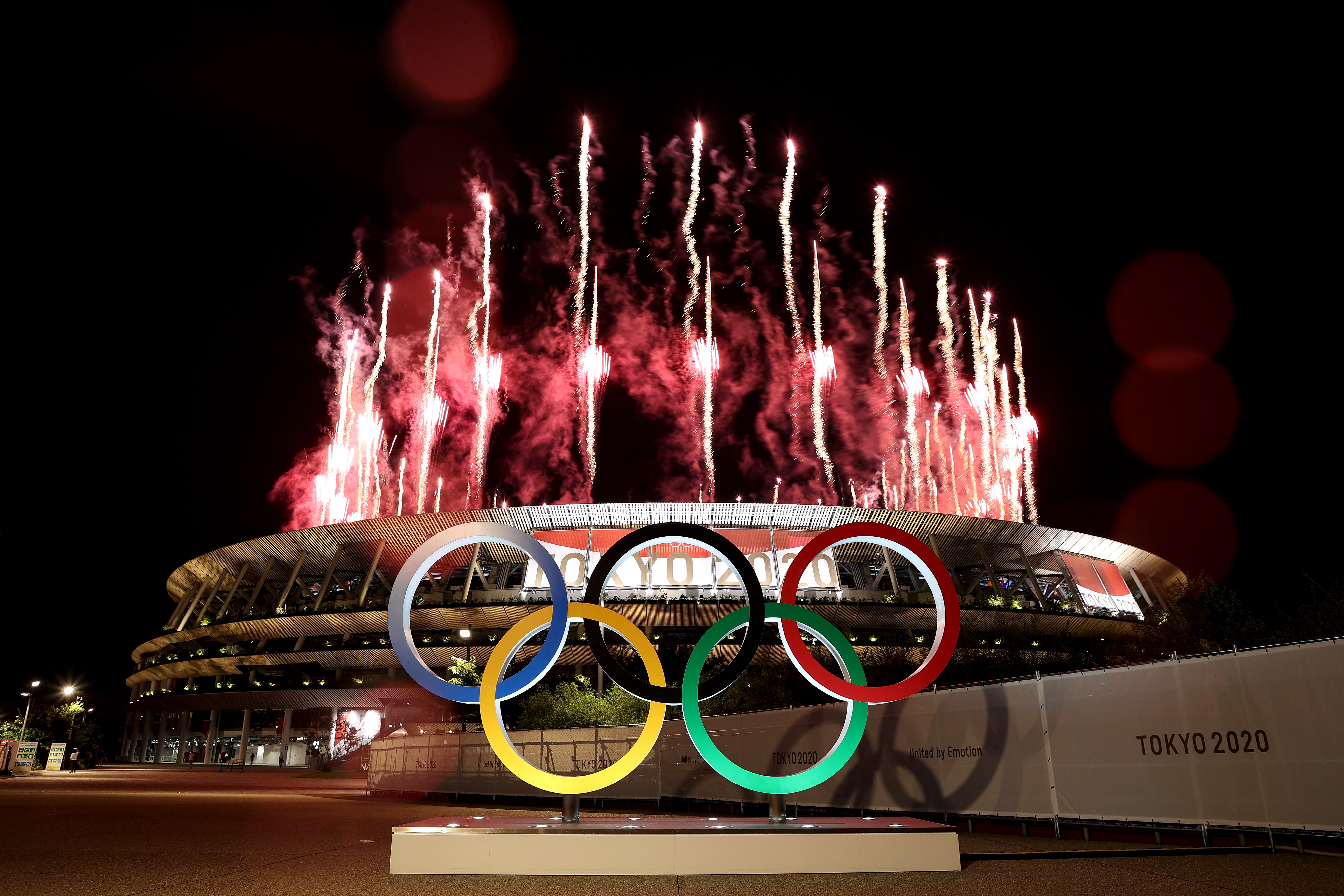 Fireworks light up the night sky during the opening ceremony of the Tokyo 2020 Olympic Games on 23 July.