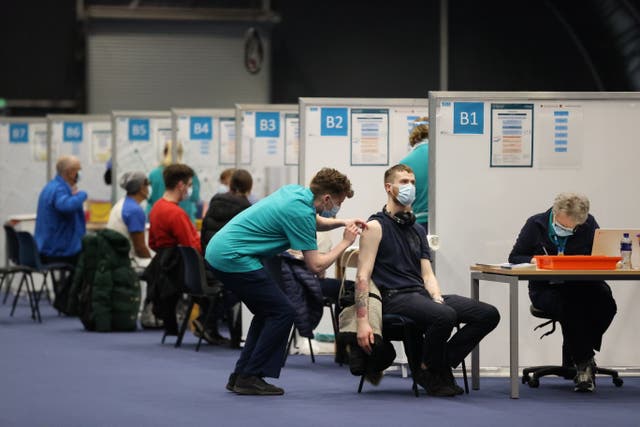 People get Covid-19 vaccinations at the Titanic Exhibition Centre in Belfast (Liam McBurney/PA)