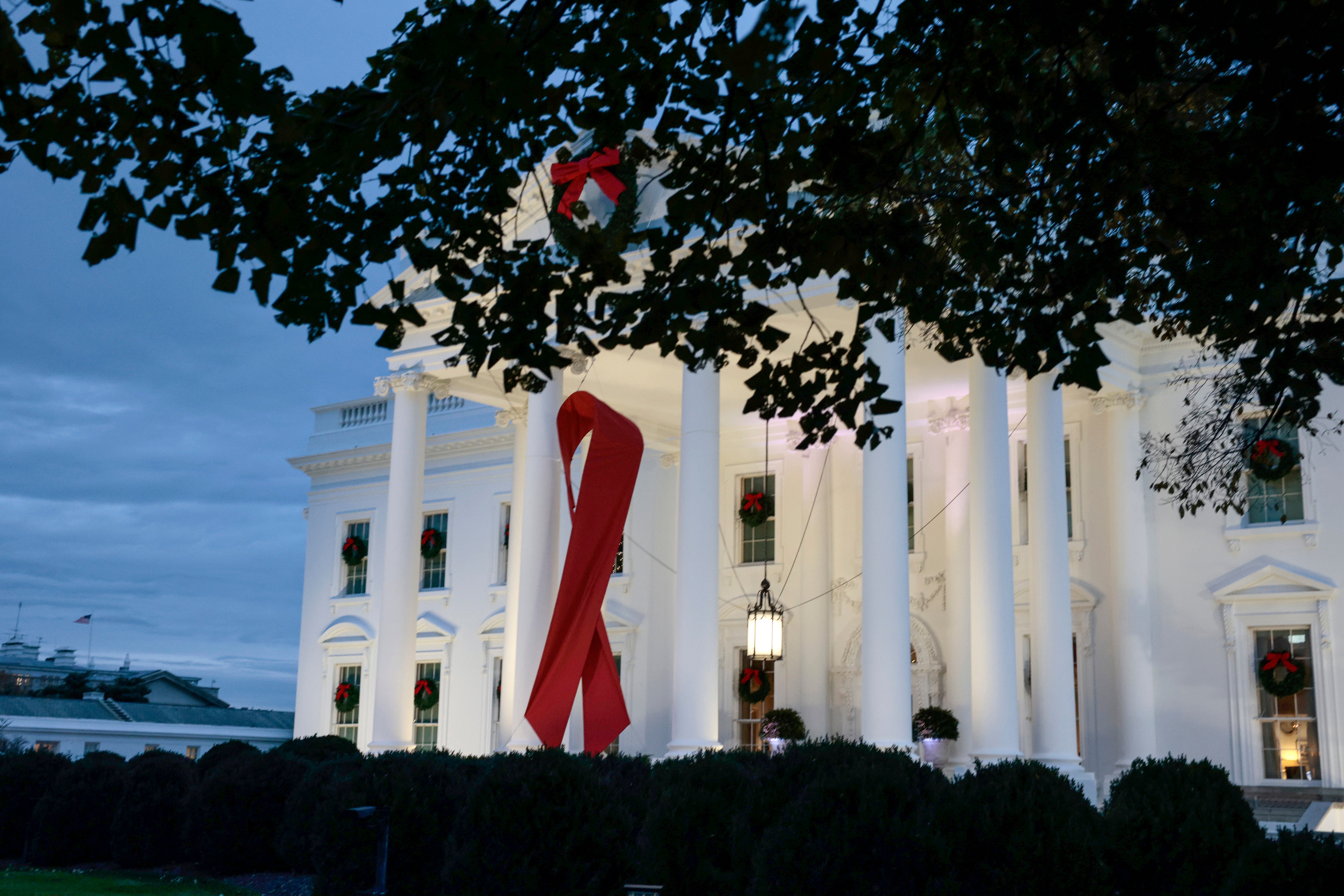 A red ribbon is displayed on the North Portico of the White House to recognize World AIDS Day on 1 December, 2021 in Washington.