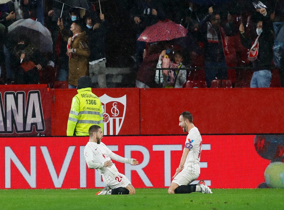 Sevilla’s Papu Gomez, left, celebrates with Ivan Rakitic after scoring the opening goal against Barcelona (Angel Fernandez/AP)