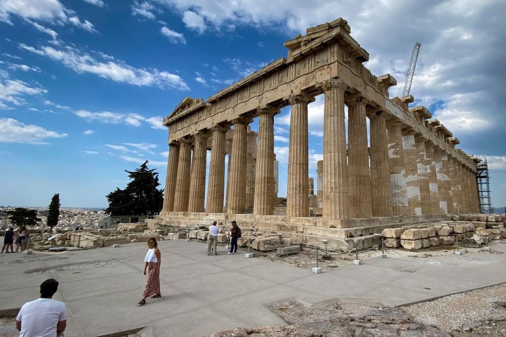Tourists visit the Parthenon on the Acropolis hill in Athens
