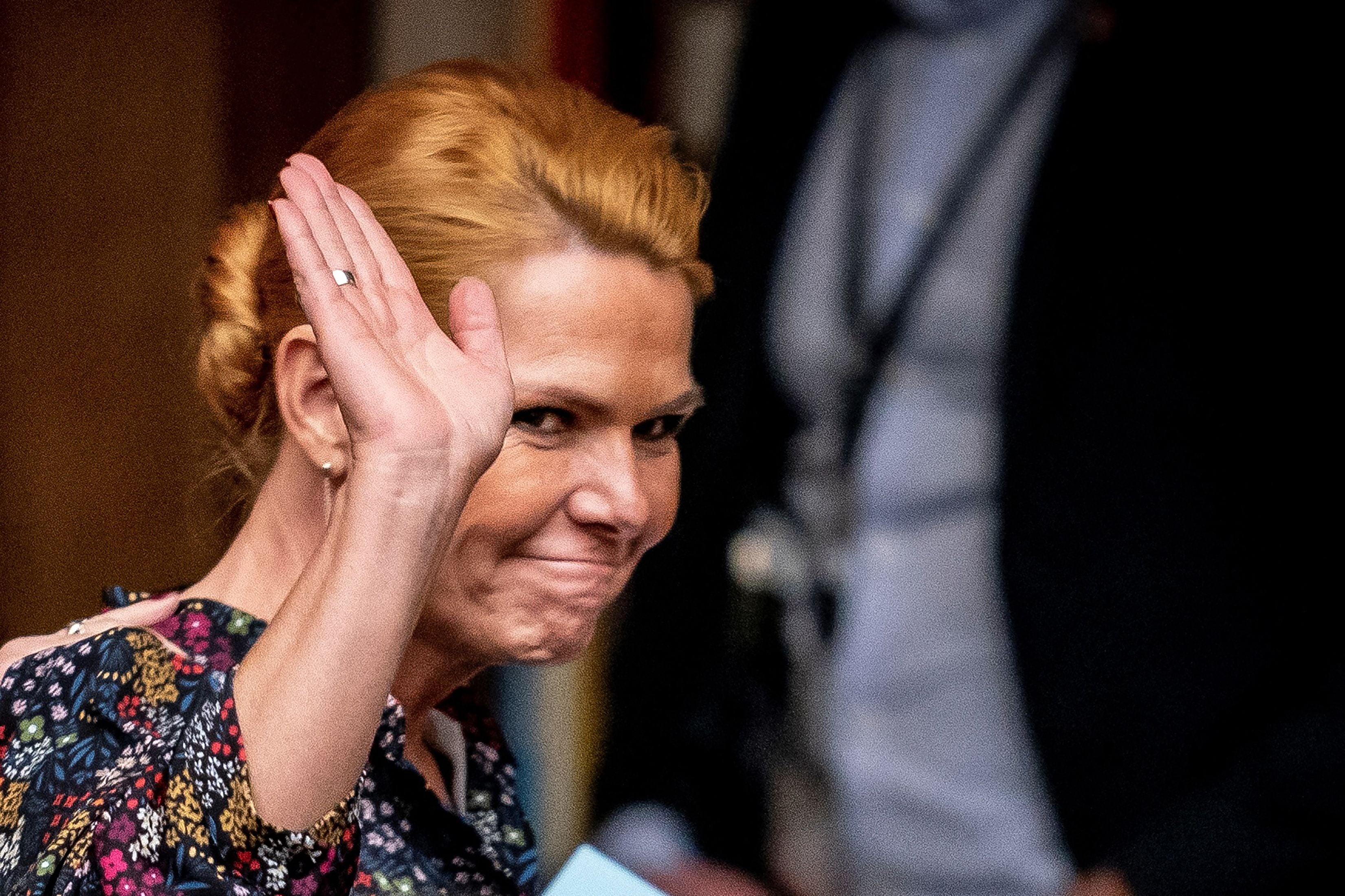 Former Danish migration minister Inger Stojberg waves as she leaves parliament in Copenhagen on 21 December 2021