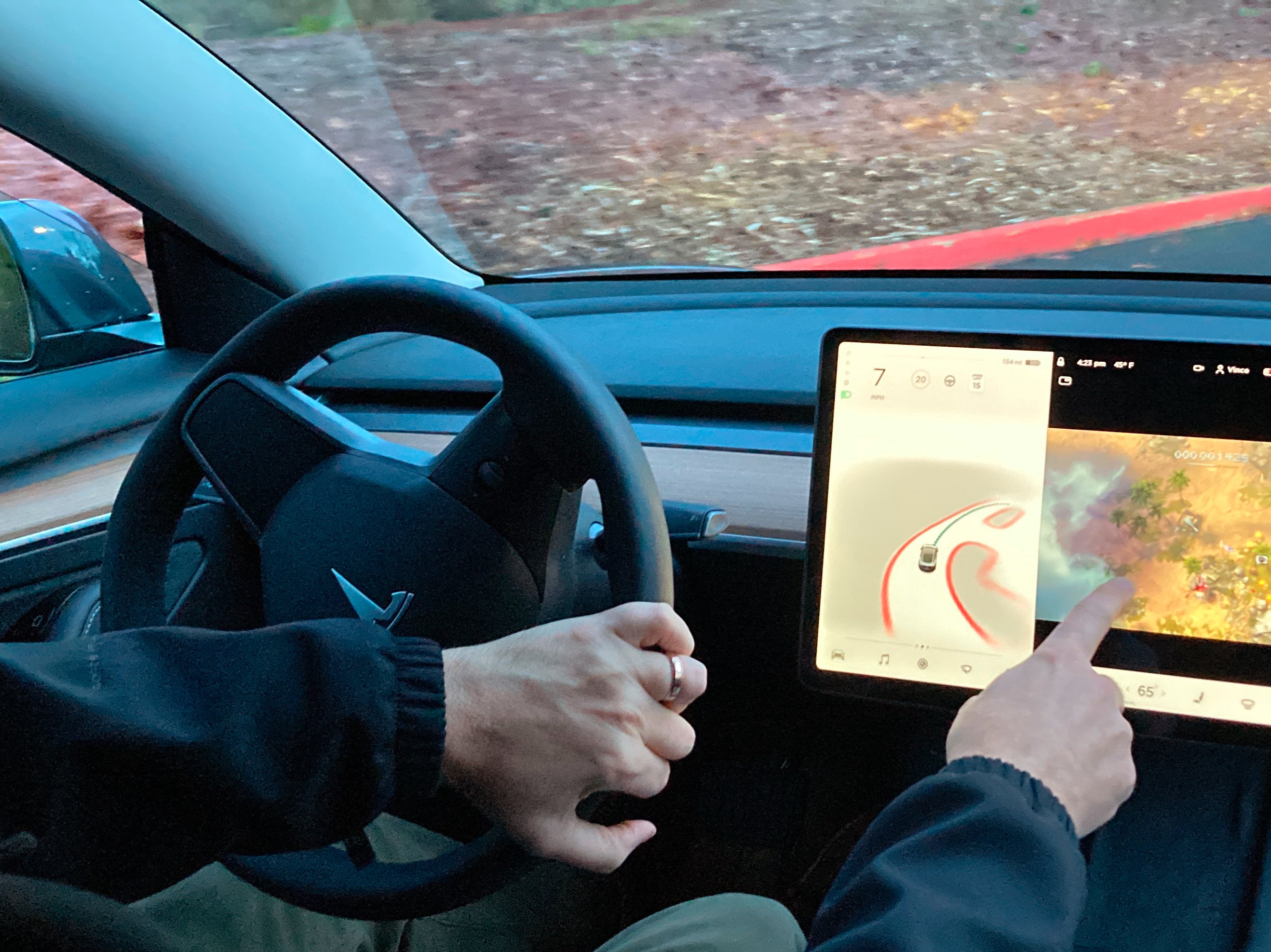 <p>A Tesla owner demonstrating how he was able to play games at the wheel of a vehicle </p>