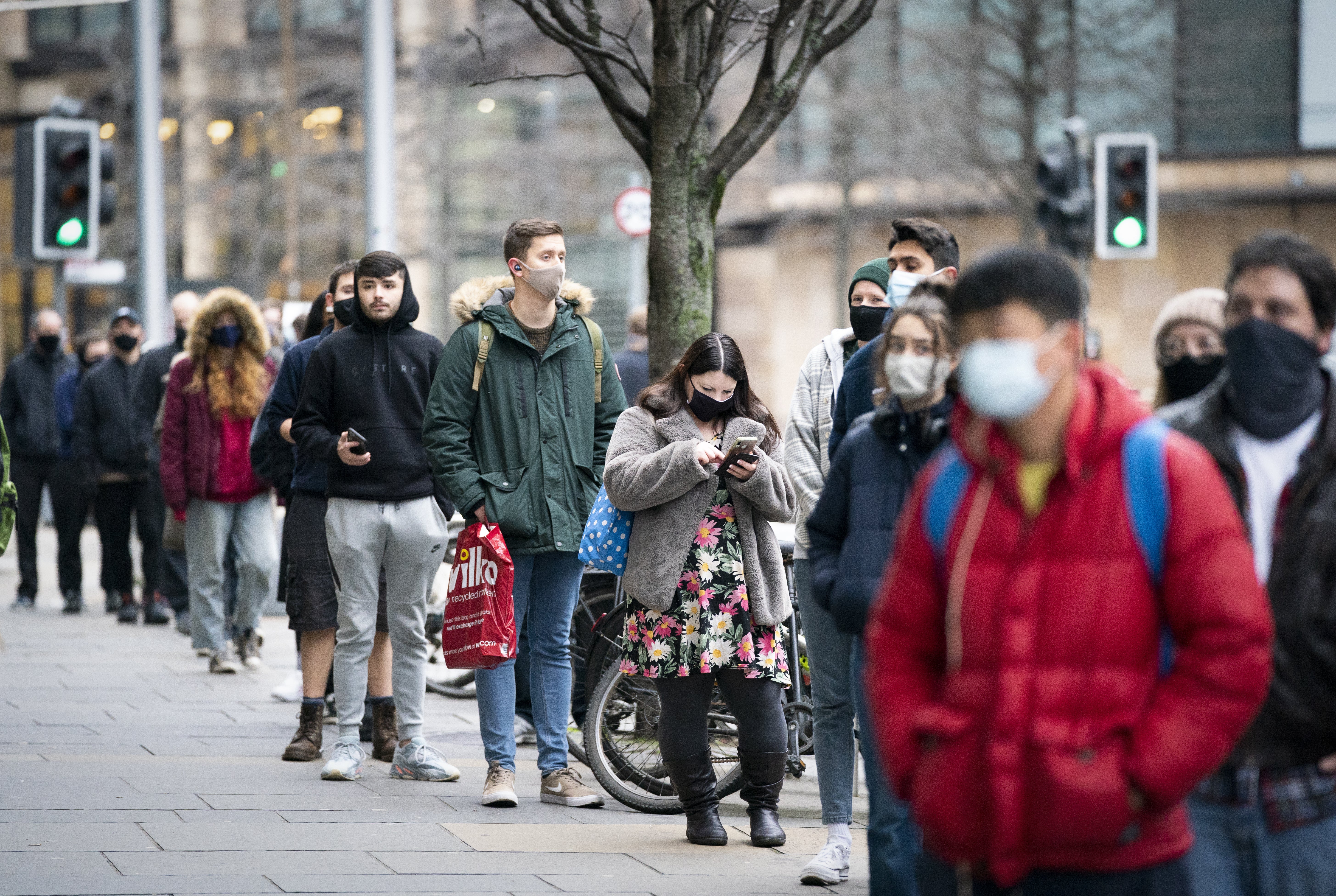 People queue outside the Edinburgh International Conference Centre for the NHS Scotland vaccination centre (Jane Barlow/PA)