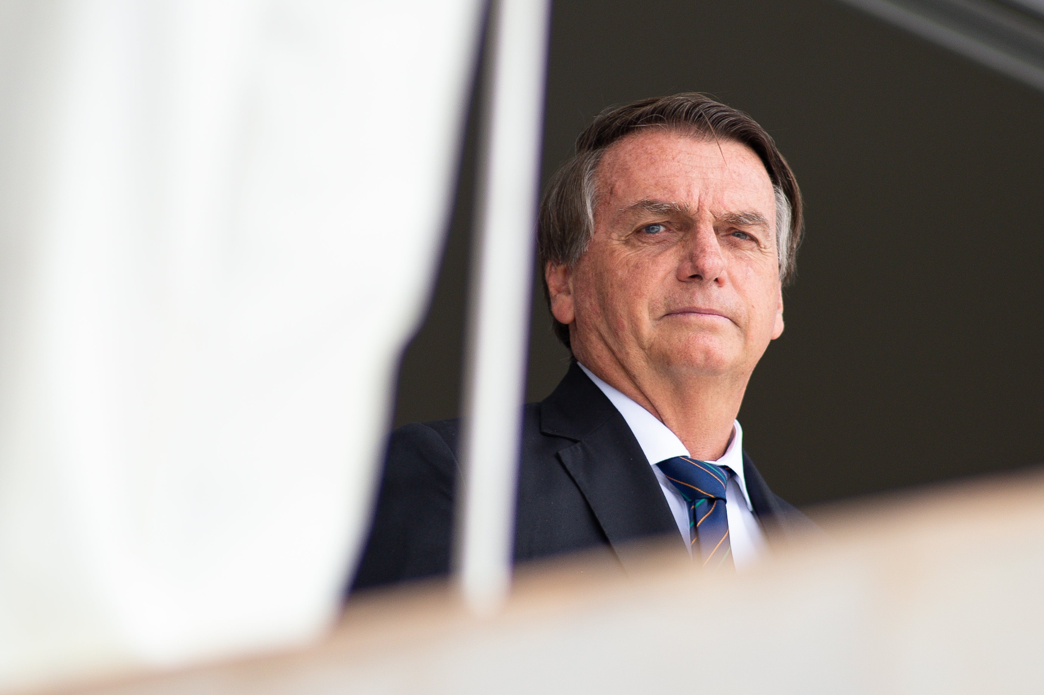 File: President of Brazil Jair Bolsonaro reacts during the exchange of the presidential guard at Planalto Palace on 16 December 2021 in Brasilia, Brazil
