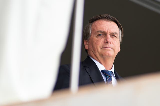 <p>File:  President of Brazil Jair Bolsonaro reacts during the exchange of the presidential guard at Planalto Palace on 16 December 2021 in Brasilia, Brazil</p>