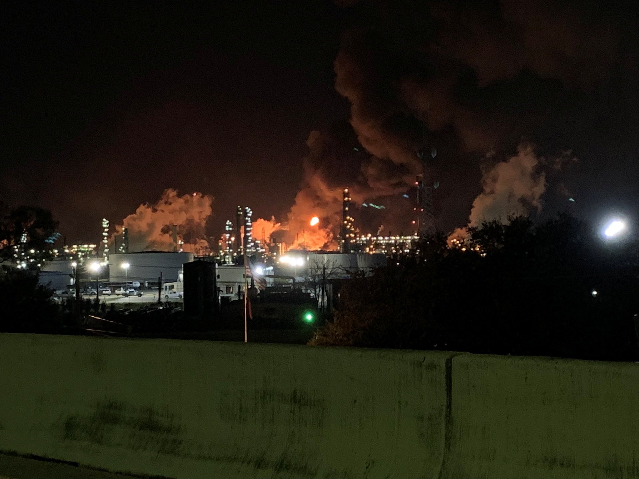 View from the road of a fire at petrochemical company ExxonMobil's refinery near Houston in Baytown, Texas