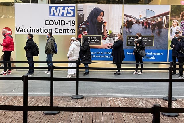 People queuing at a Covid-19 vaccination centre at the Westfield shopping centre in Stratford, east London (Jonathan Brady/PA)