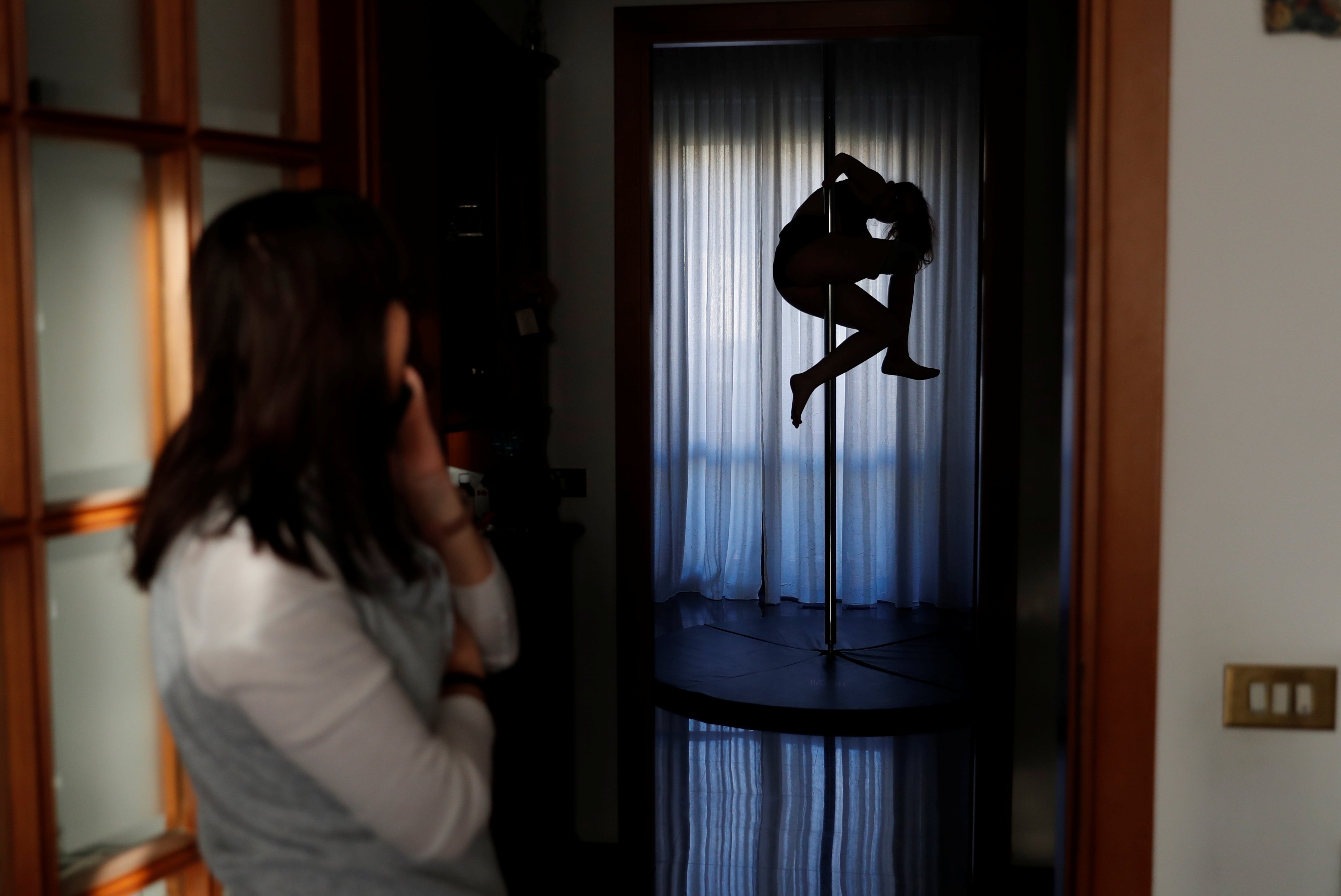 Francesca dances in the dark at home while her mother, Valeria Mencaroni, watches