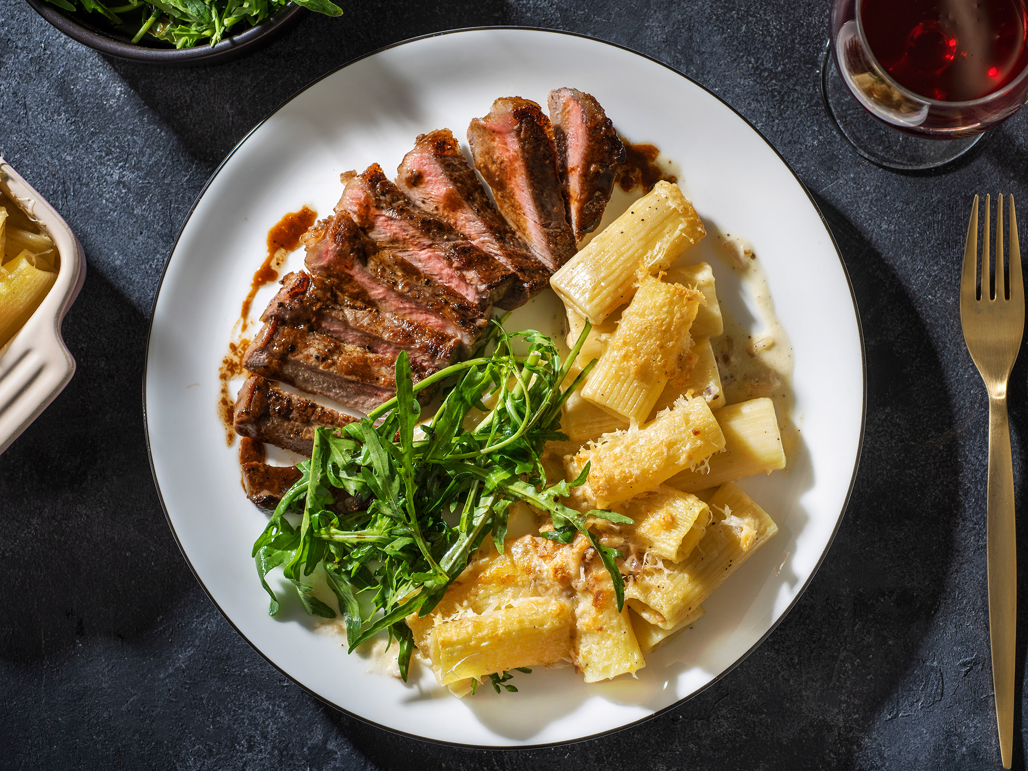 Steak and truffled pasta with a side of rucola salad