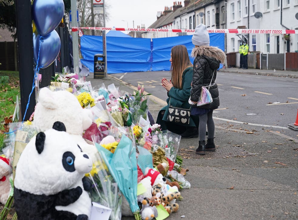 People lay flowers near the scene in Sutton, south London, where two sets of twin boys, aged three and four, died in a house fire (Yui Mok/PA)