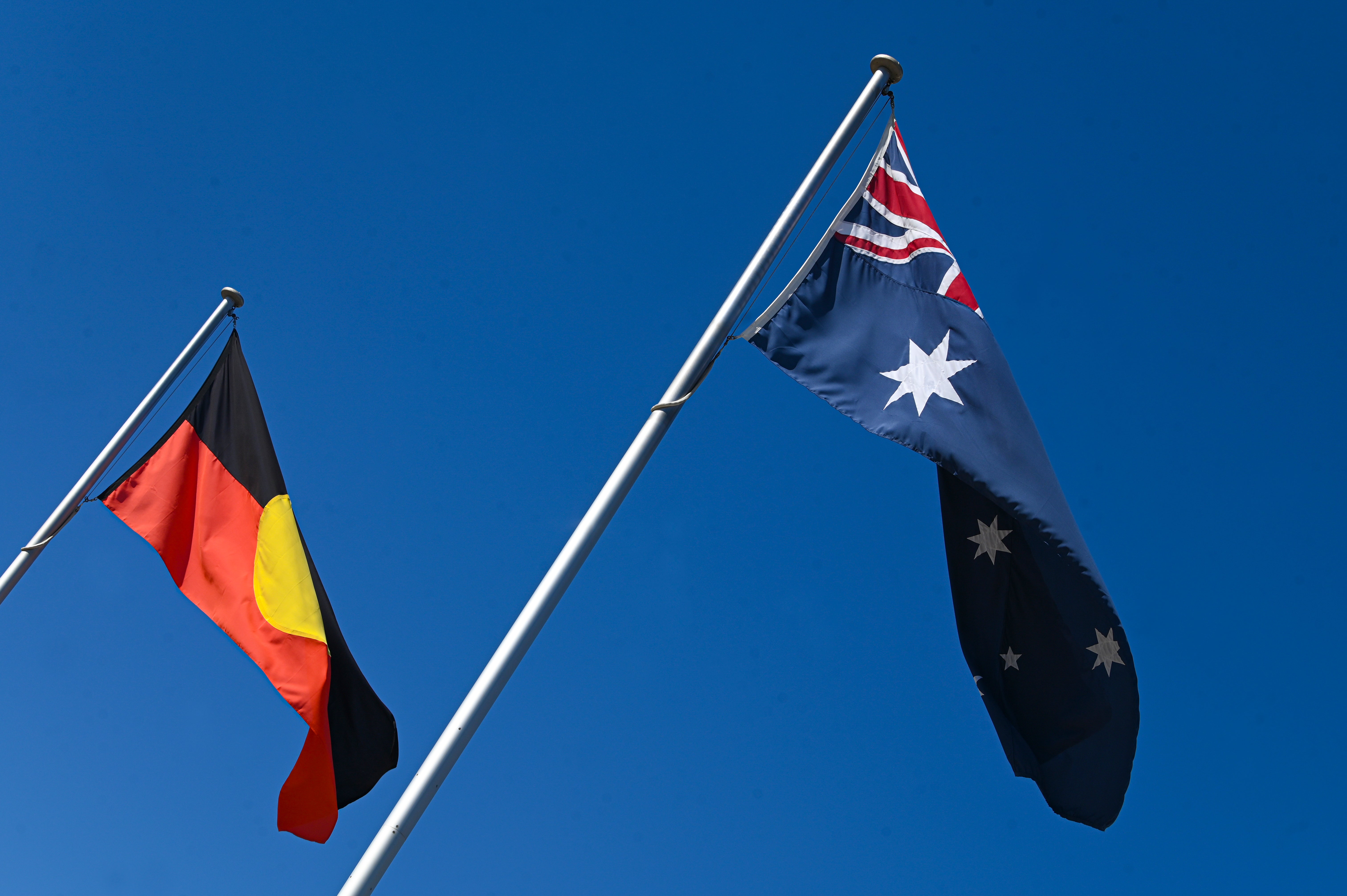 An Australian Aboriginal flag flies next to the Australian national flag in Canberra