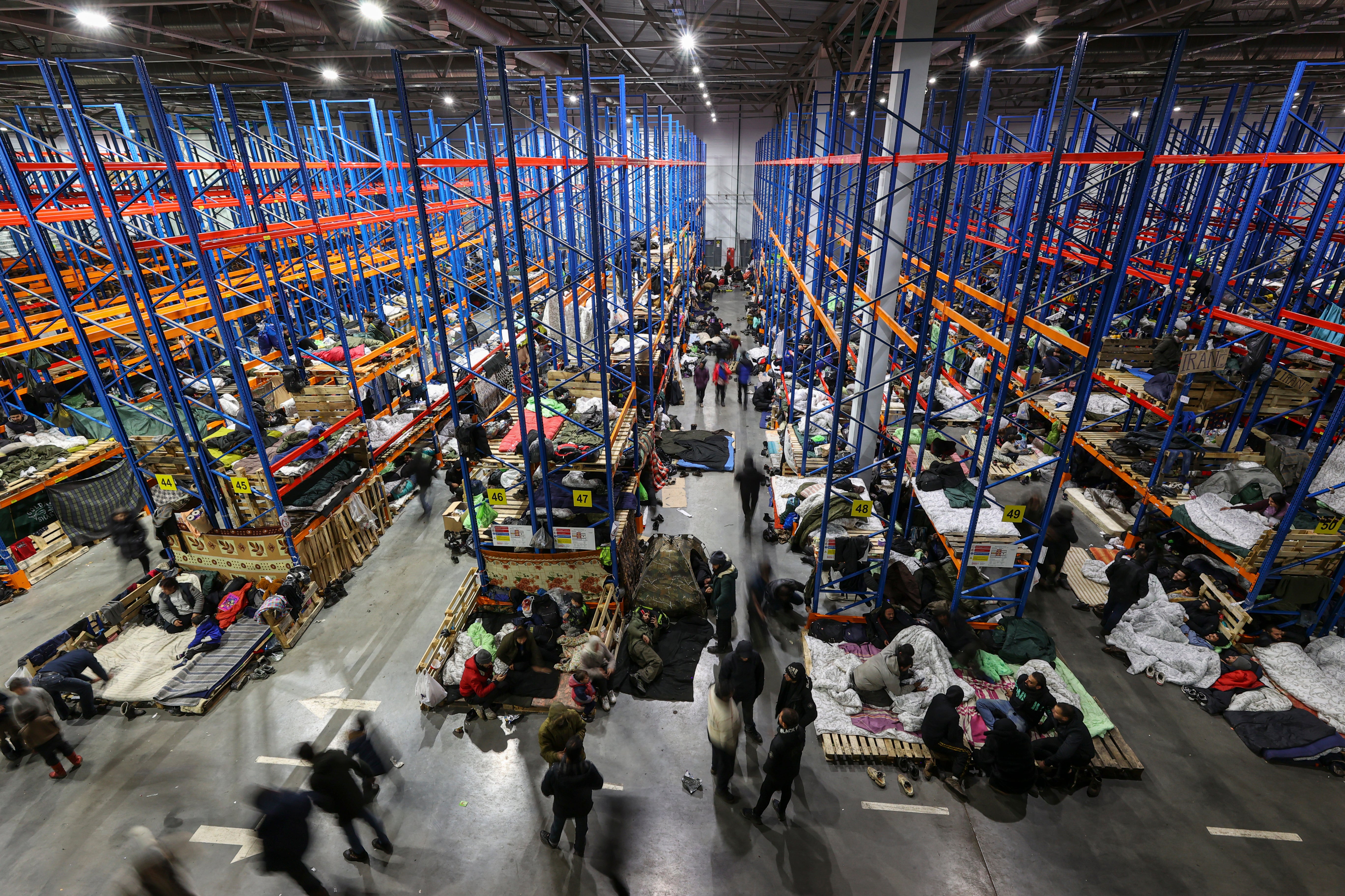 Migrants in a warehouse at the Belarusian-Polish border, in the Grodno region of Belarus
