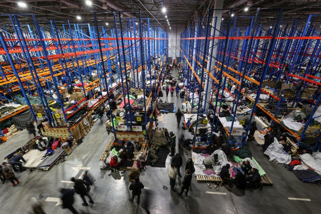 <p>Migrants in a warehouse at the Belarusian-Polish border, in the Grodno region of Belarus</p>