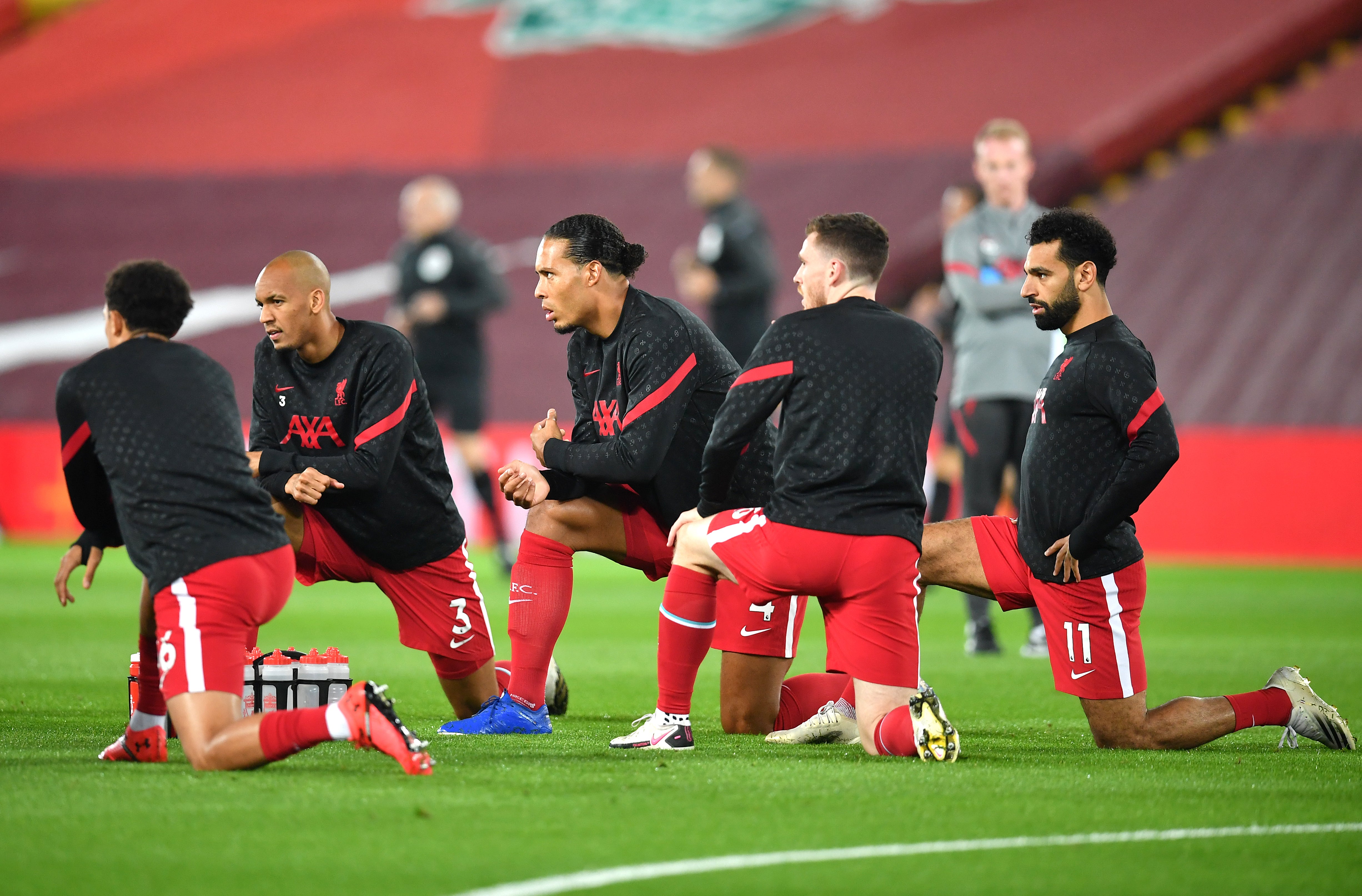 Liverpool’s Trent Alexander-Arnold (left), Fabinho, Virgil van Dijk, Andrew Robertson and Mohamed Salah (right) warming up before the Premier League match at Anfield, Liverpool.