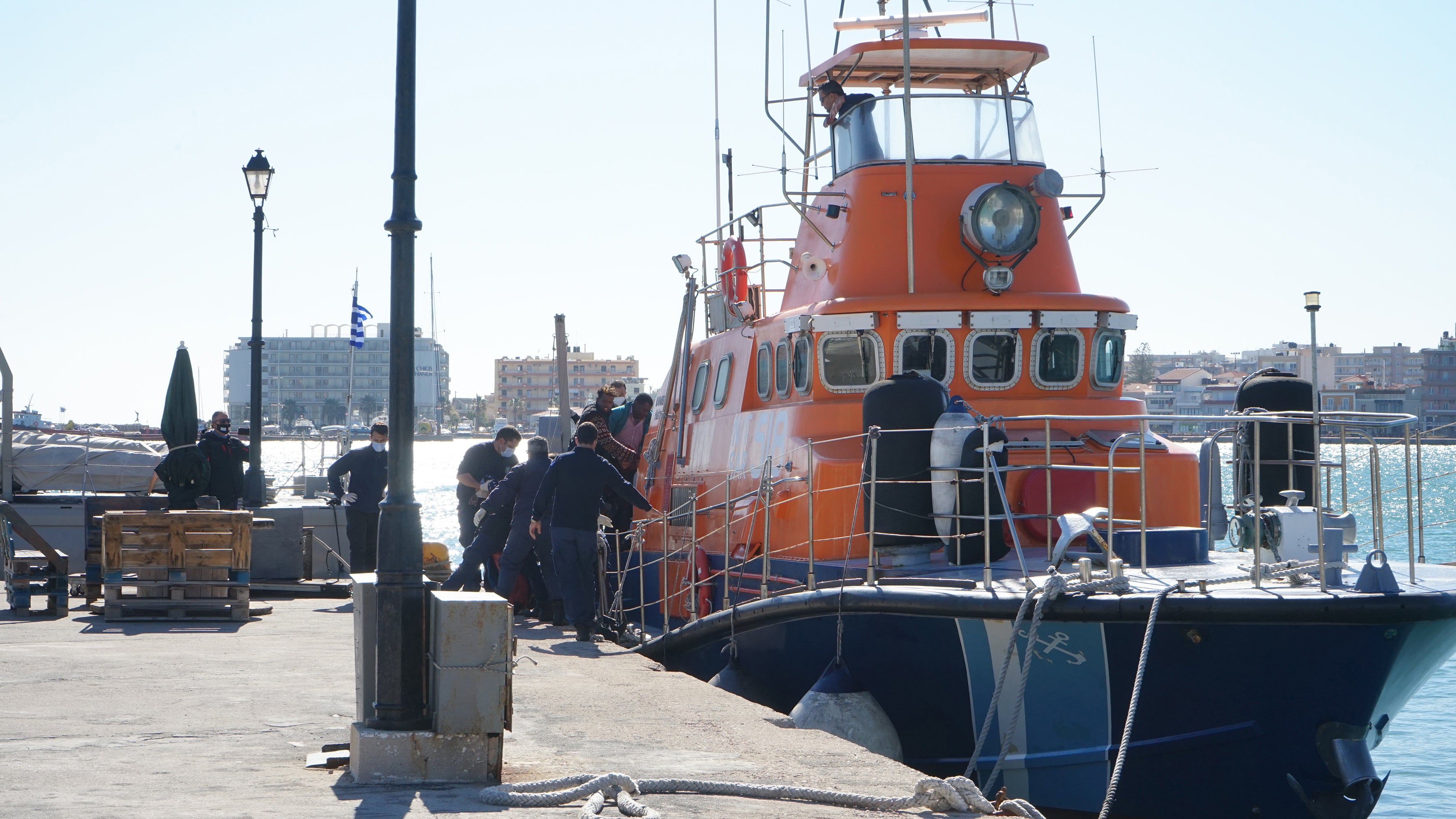 <p>Rescued migrants disembark a coastguard boat at Chios Island, Greece, in October </p>