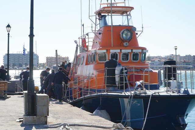 <p>Rescued migrants disembark a coastguard boat at Chios Island, Greece, in October </p>