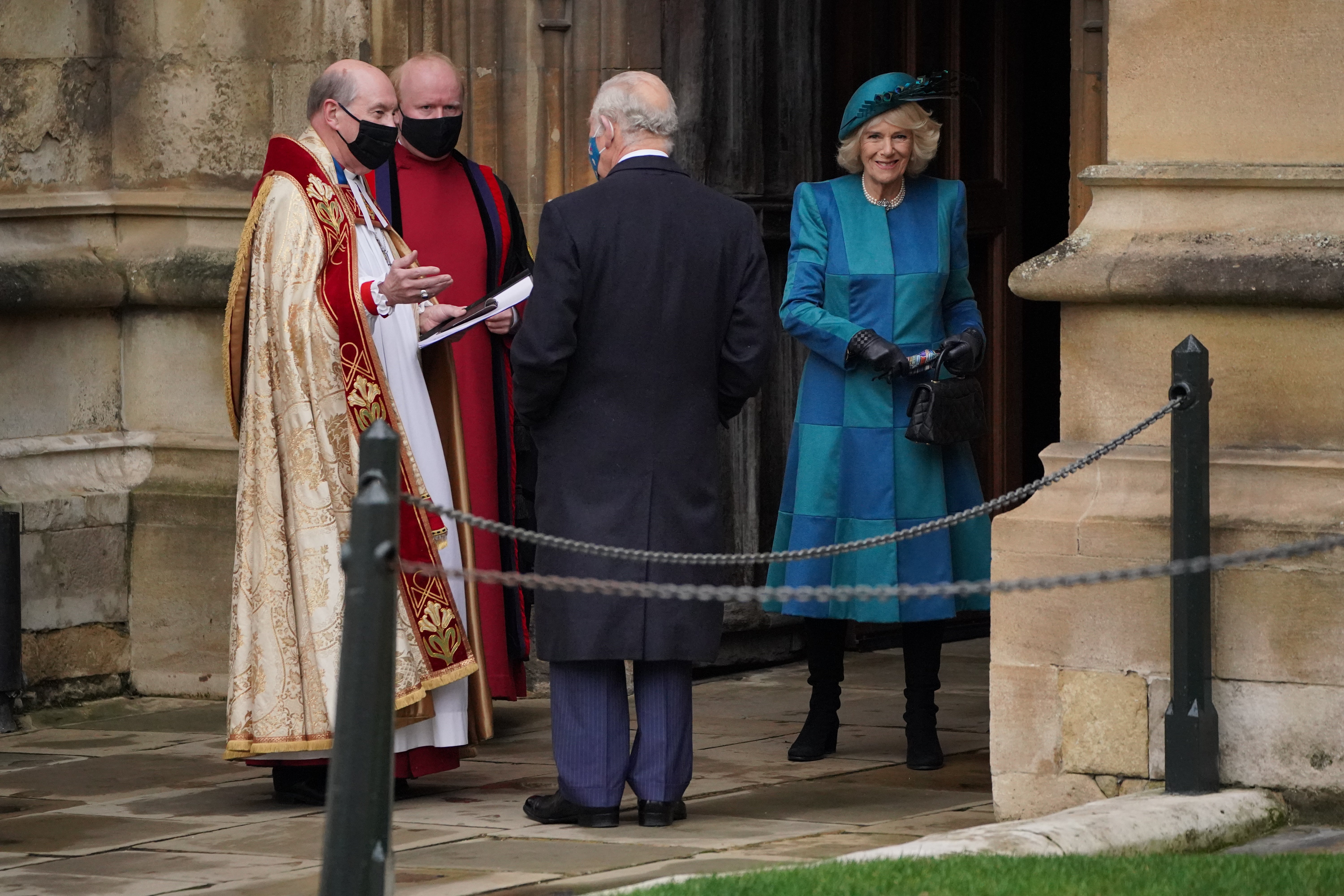 The Prince of Wales and the Duchess of Cornwall are greeted by the Dean of Windsor (Jonathan Brady/PA)