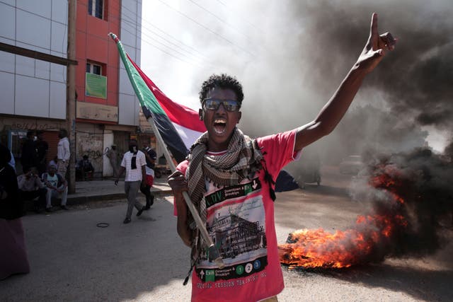 <p>A man chants slogans during a protest to denounce the October military coup, in Khartoum, Sudan, 25 December 2021</p>