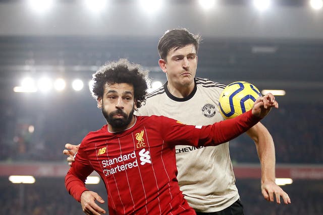 Liverpool’s Mohamed Salah (left) and Manchester United’s Harry Maguire battle for the ball (Martin Rickett/PA).