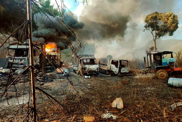 <p>Flames and smoke billow from vehicles after the ambush </p>