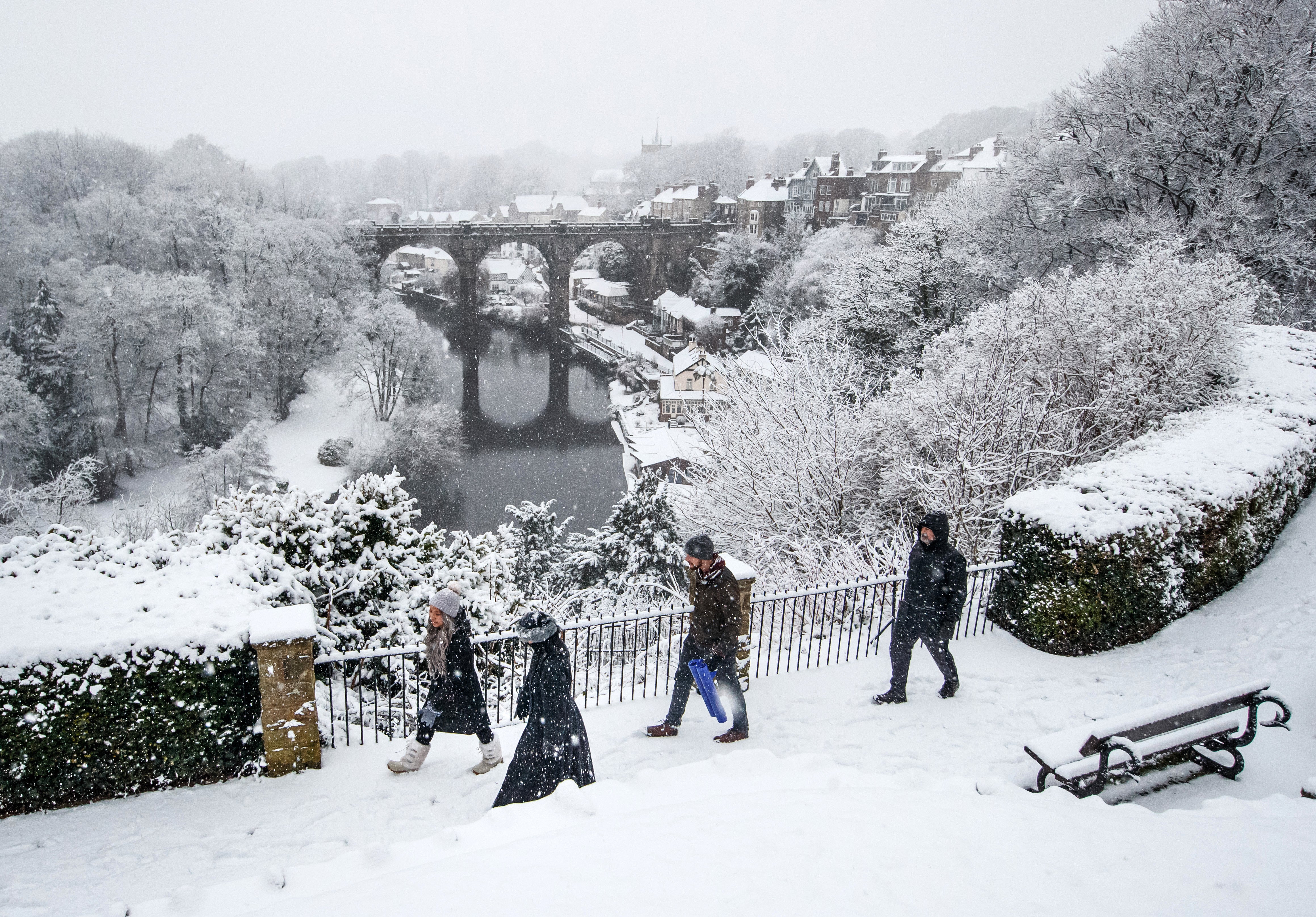 People walk in the snow near Knaresborough Viaduct in North Yorkshire (Danny Lawson/PA)