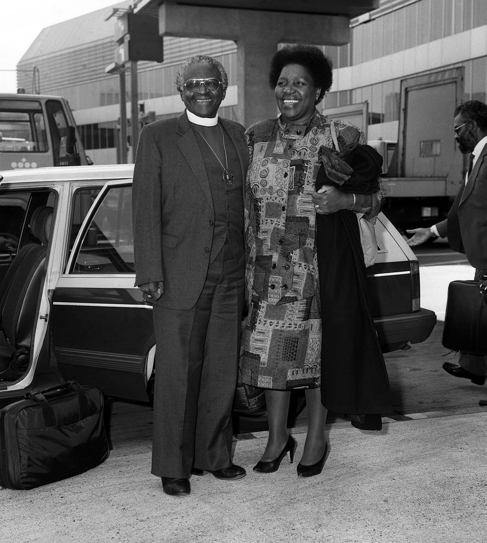 Desmond Tutu, with his wife Leah at Heathrow Airport (PA)