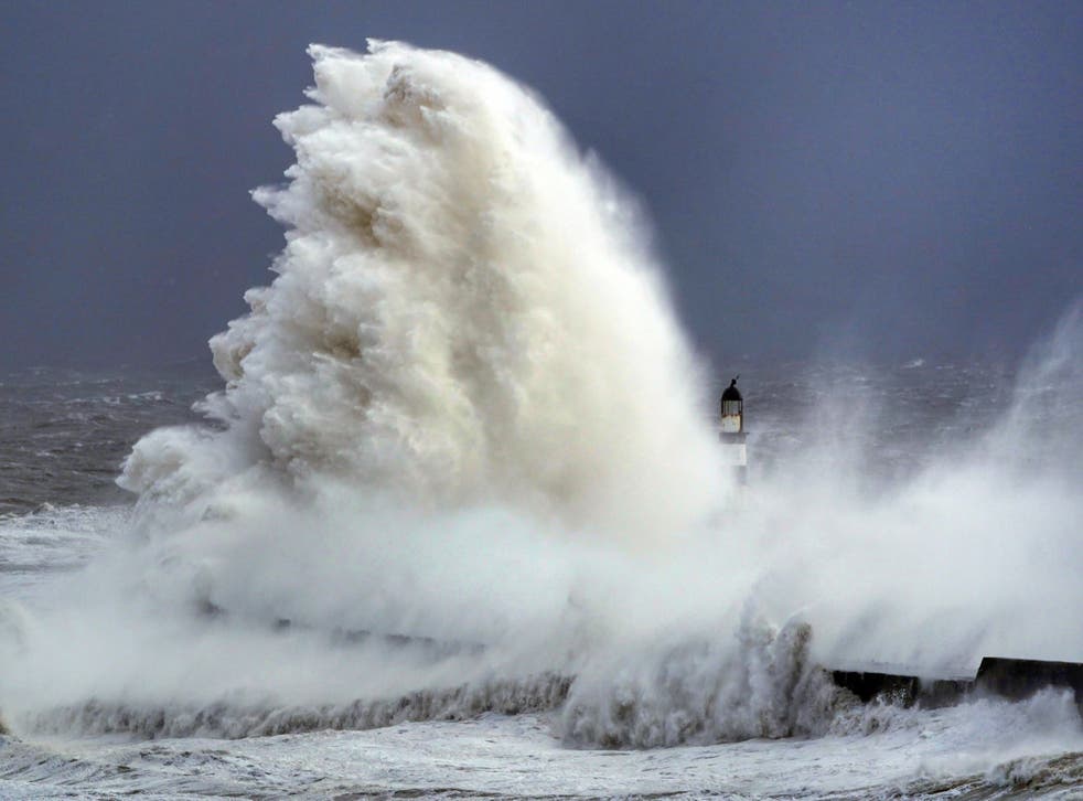 Huge waves crash against the lighthouse in Seaham Harbour, County Durham, during Storm Arwen (Owen Humphreys/PA)