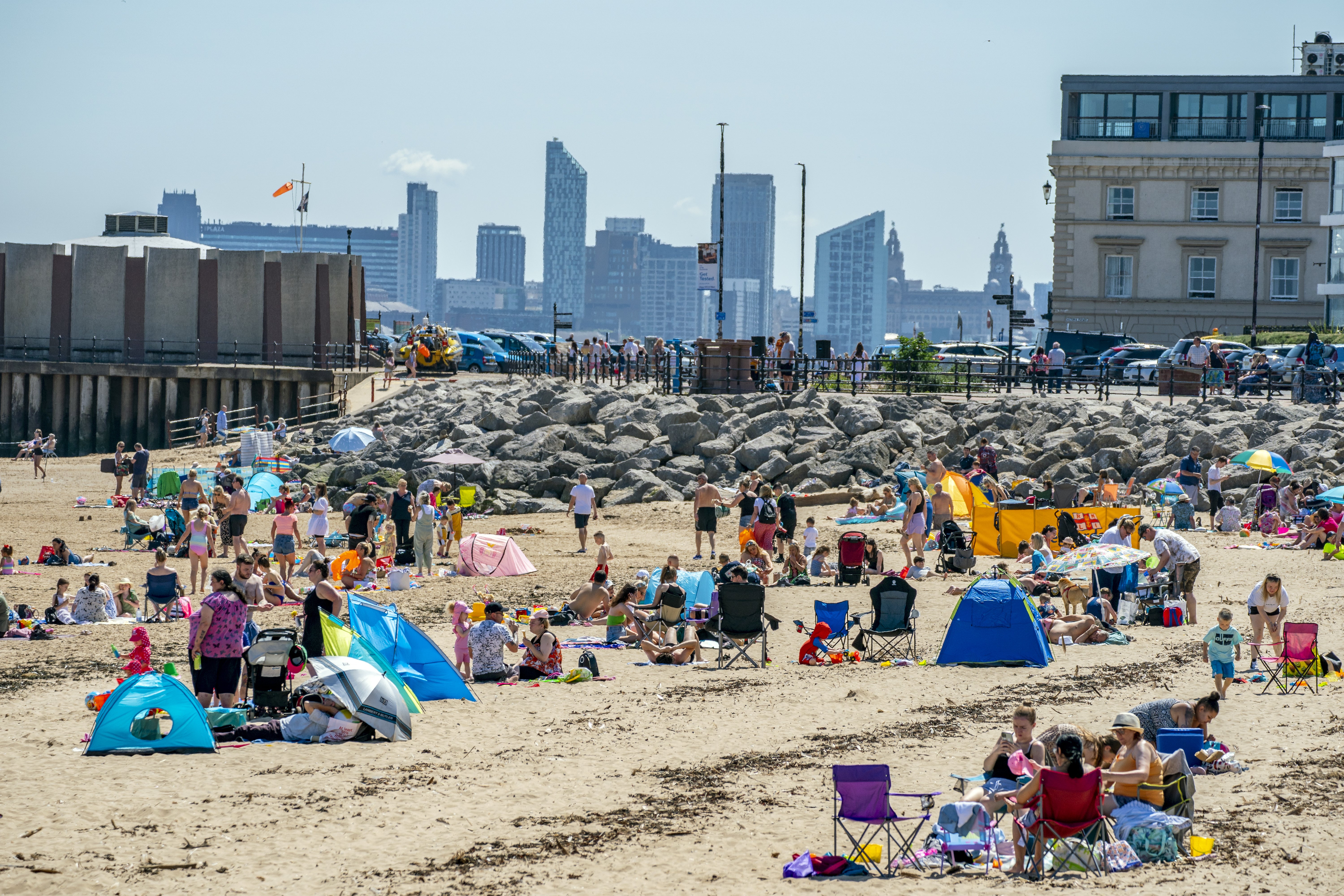 Sunbathers make the most of the mini heatwave in New Brighton, Wirral (Peter Byrne/PA)
