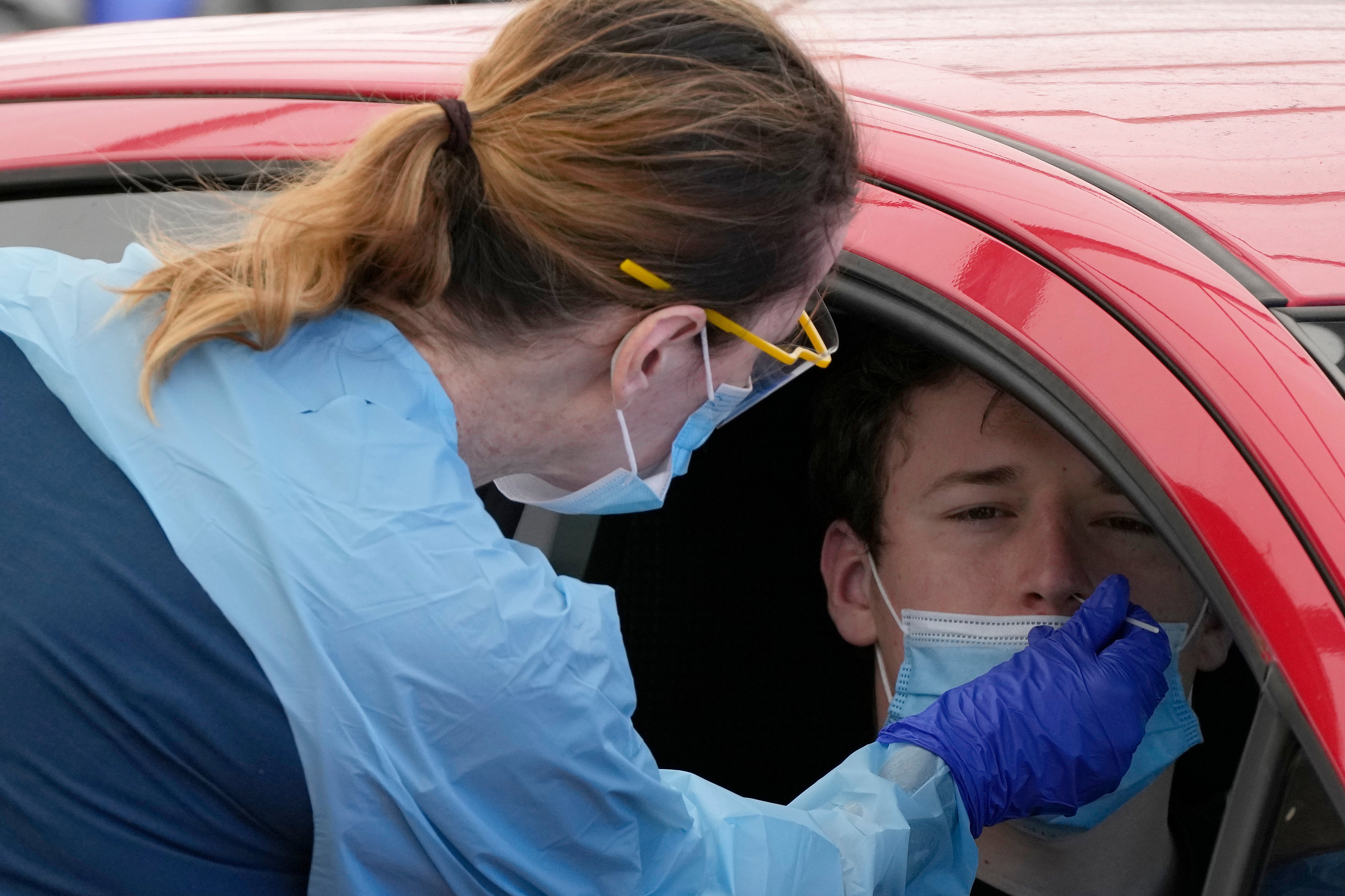 File: A man has a swab taken at a drive-through Covid testing clinic in Australia