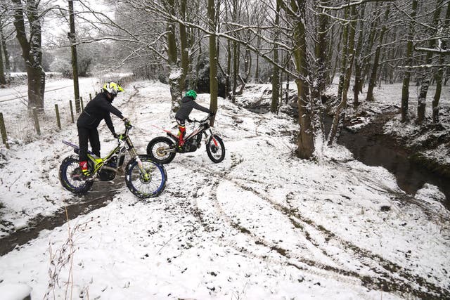 Riders take their bikes through the snow near Castleside, County Durham