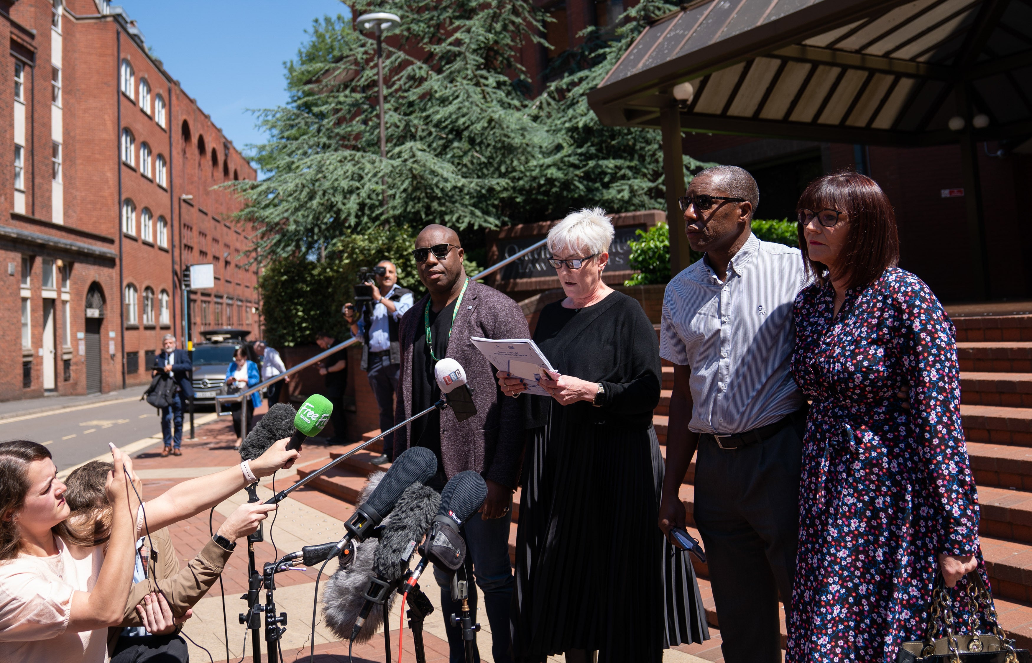 Lawyers for the Atkinson family pictured outside court with Kenroy Atkinson, brother of Dalian, and his wife Julie (R), in June (Joe Giddens/PA)