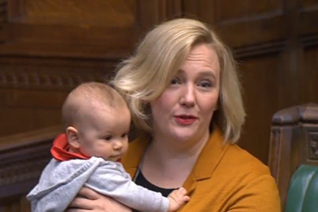 <p>Labour MP Stella Creasy holds her baby daughter in the House of Commons</p>