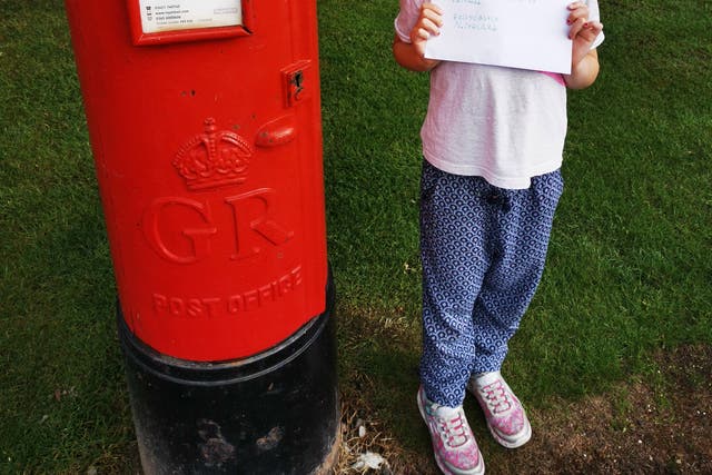 Cora Kelly Bell posting her letter to her grandmother Anne Kelly (Anne Kelly/PA)