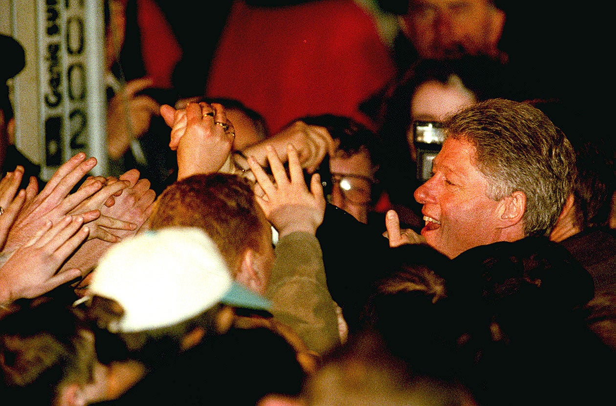 The President of the United States Bill Clinton reaches out to a sea of hands as he leaves Belfast City hall after switching on the Christmas tree lights (Adam Butler/PA)