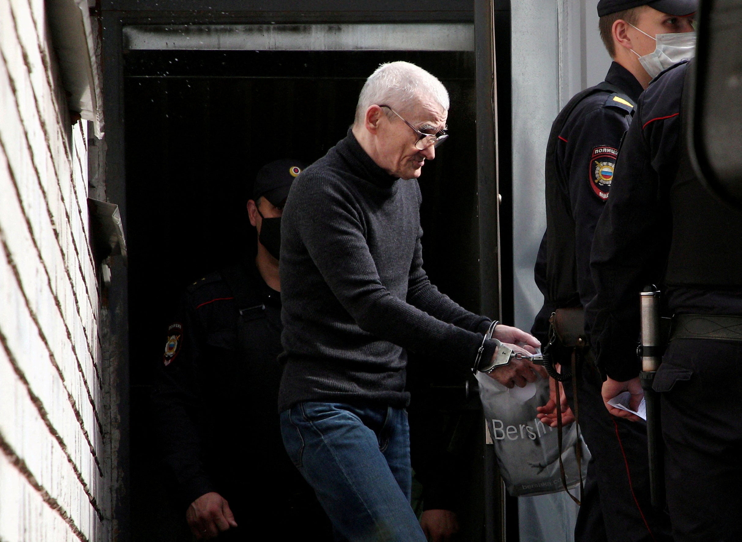 File: Russian historian Yuri Dmitriev is escorted by police officers after a court hearing in Petrozavodsk
