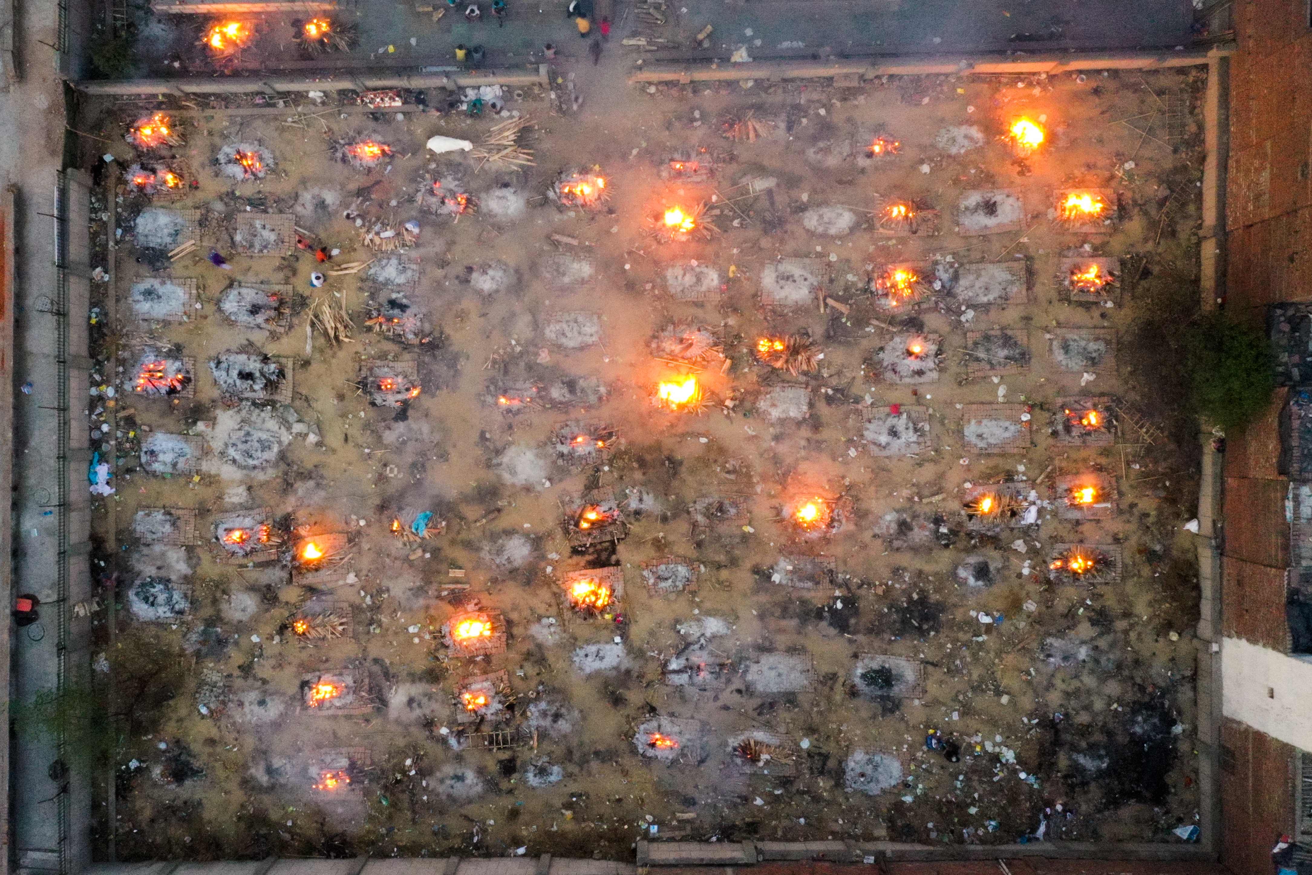 Burning pyres of victims who lost their lives due to the Covid are seen at a cremation ground in New Delhi