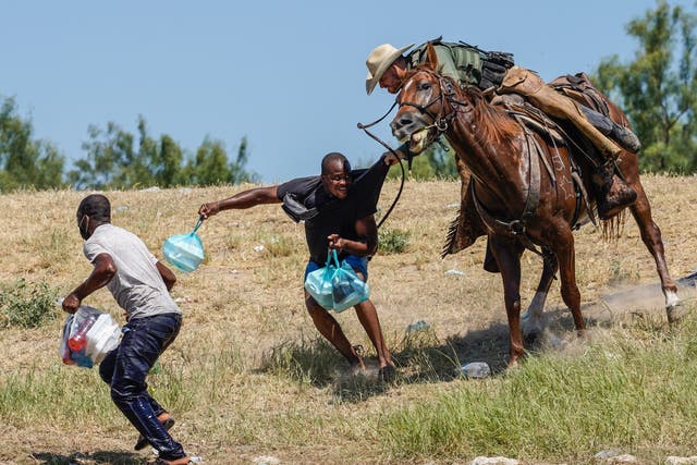 <p>A United States Border Patrol agent on horseback tries to stop a Haitian migrant from entering an encampment on the banks of the Rio Grande near the Acuna Del Rio International Bridge in Del Rio, Texas on September 19, 2021 </p>