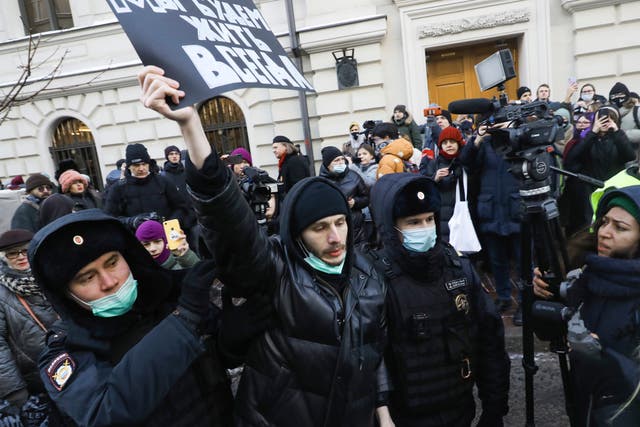 <p>Police officers detain a demonstrator as people gather in front of the Supreme Court, in Moscow on Tuesday </p>