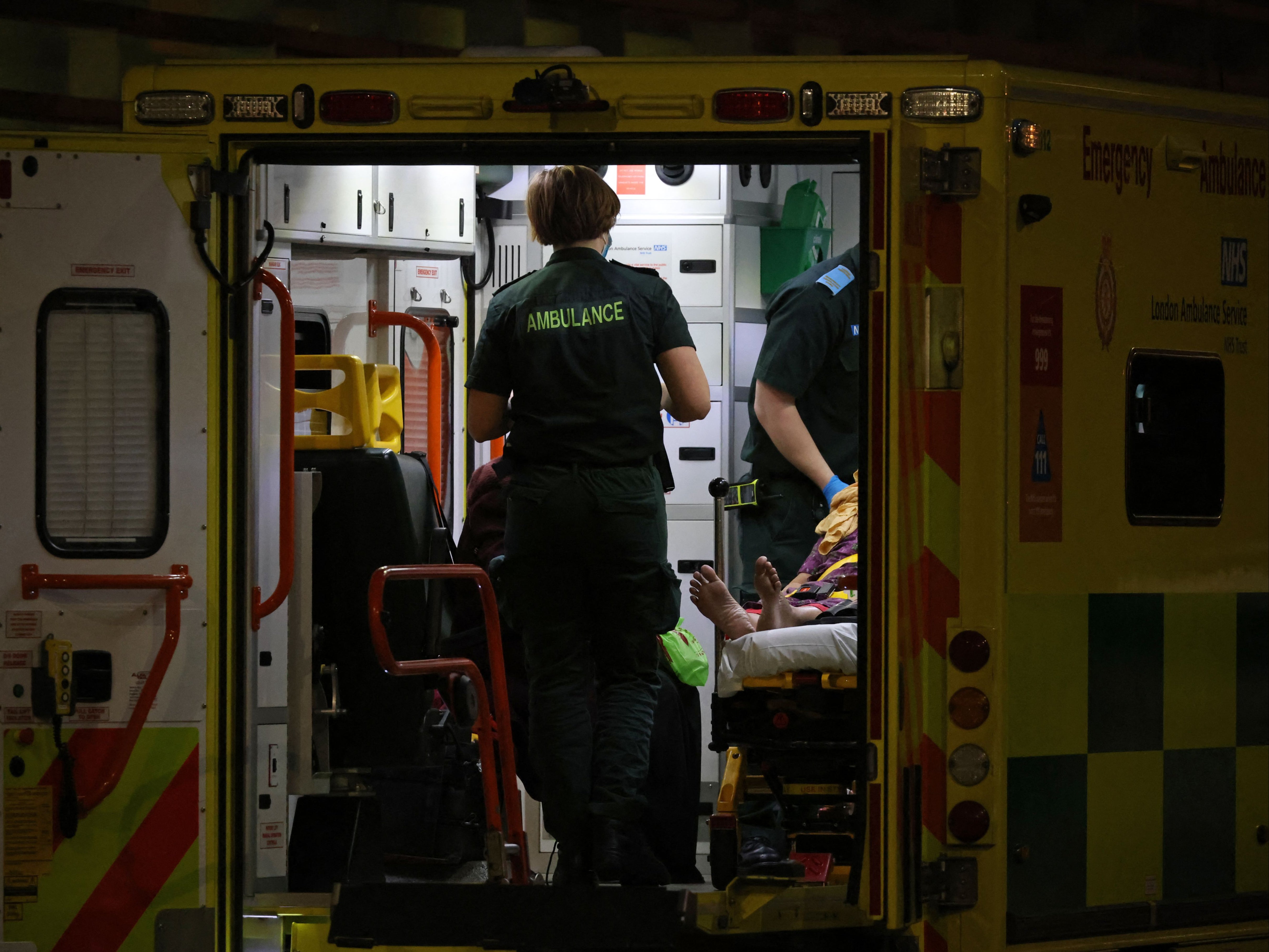 <p>An Ambulance crew bring a patient to the Royal London hospital in London on 28 December</p>