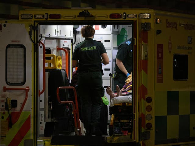 <p>An Ambulance crew bring a patient to the Royal London hospital in London on 28 December</p>