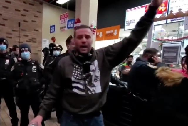 <p>A man speaking during an anti-vaccine protest at a Burger King on Monday </p>