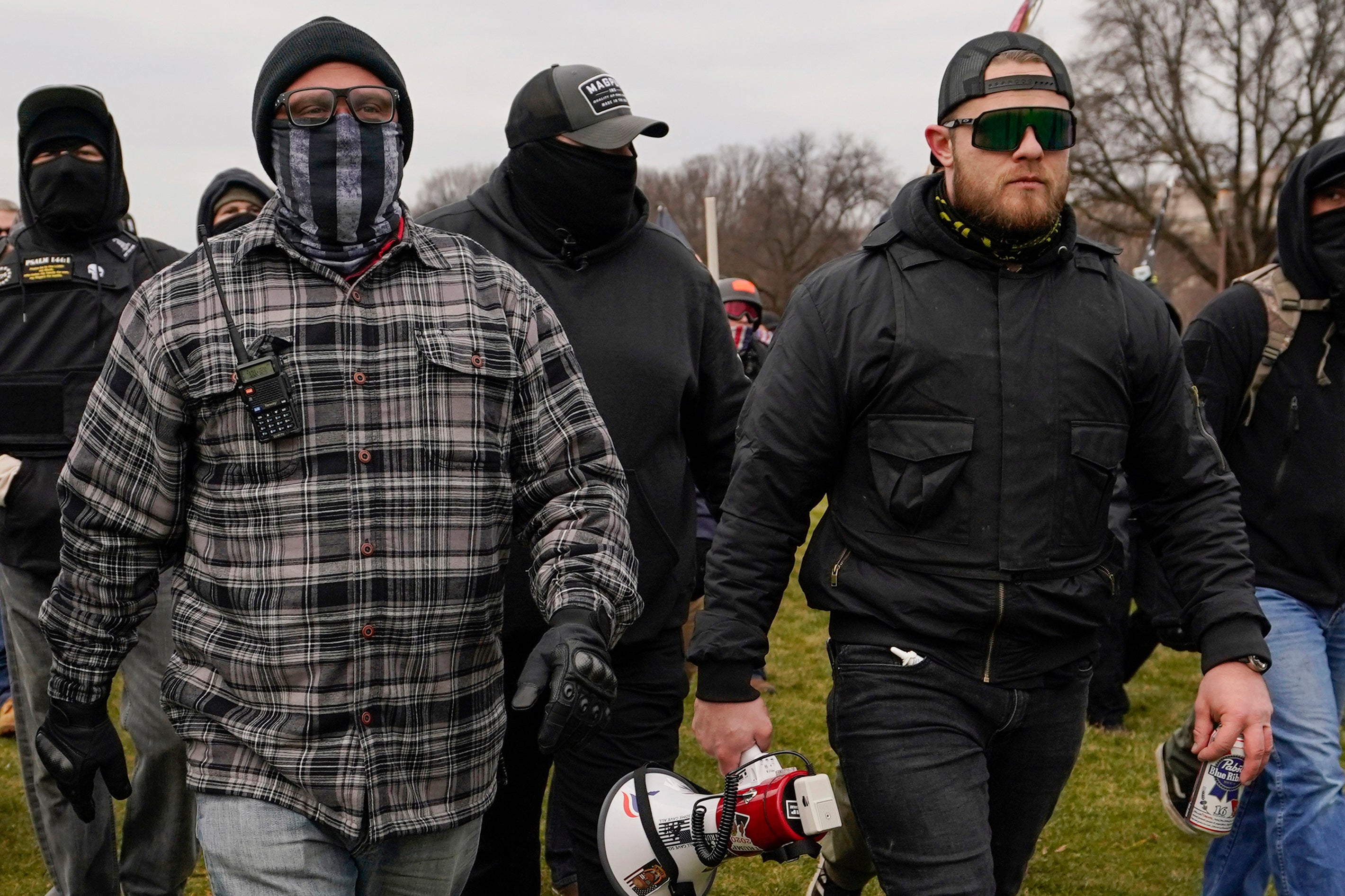 FILE - Proud Boys members Joseph Biggs, left, and Ethan Nordean, right with megaphone, walk toward the U.S. Capitol in Washington, Jan. 6, 2021.